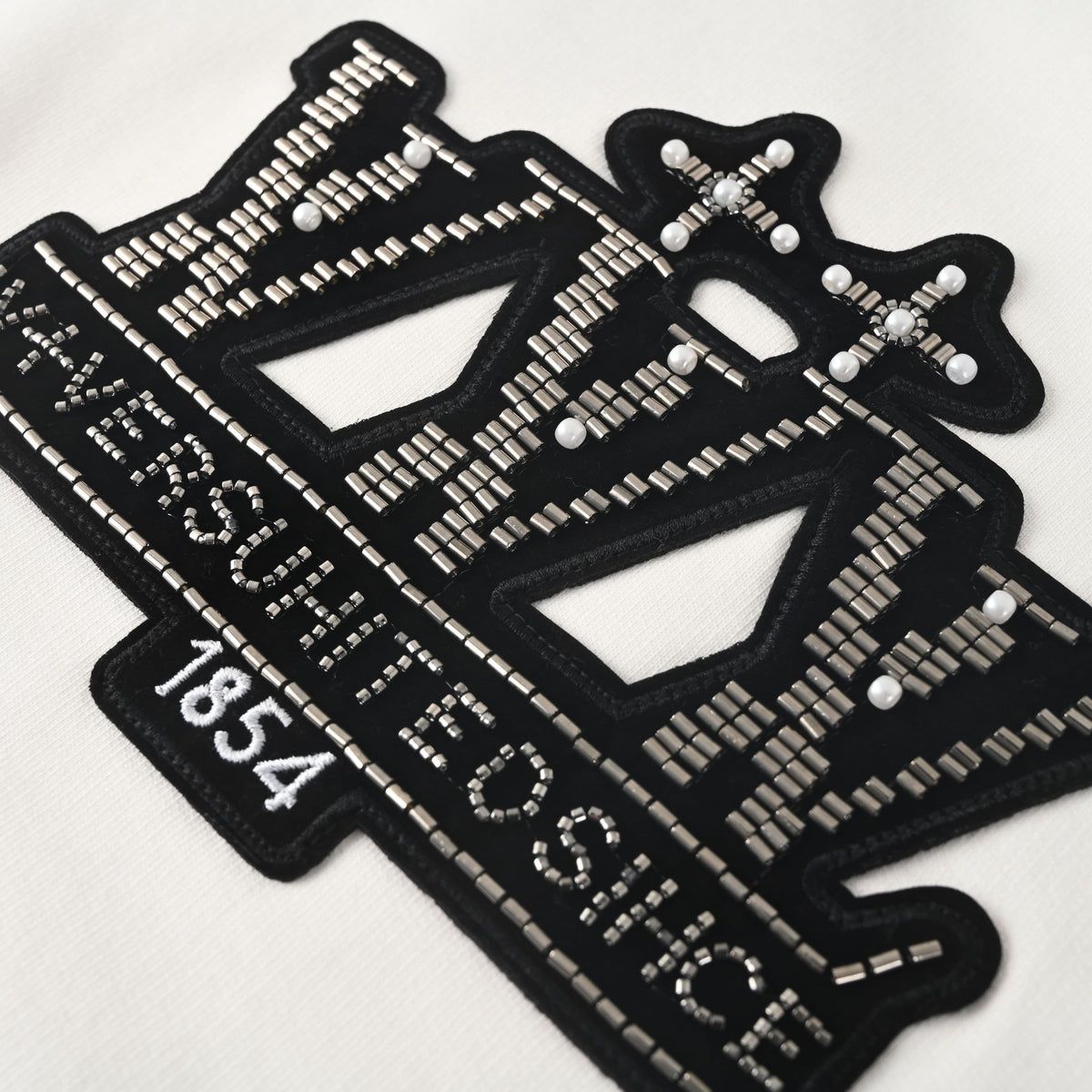 Louis Vuitton White Beaded Emblem Sweatshirt, Unisex Relaxed Cotton French Terry Crewneck with Contrasting Black Chest Design and Embroidered Details