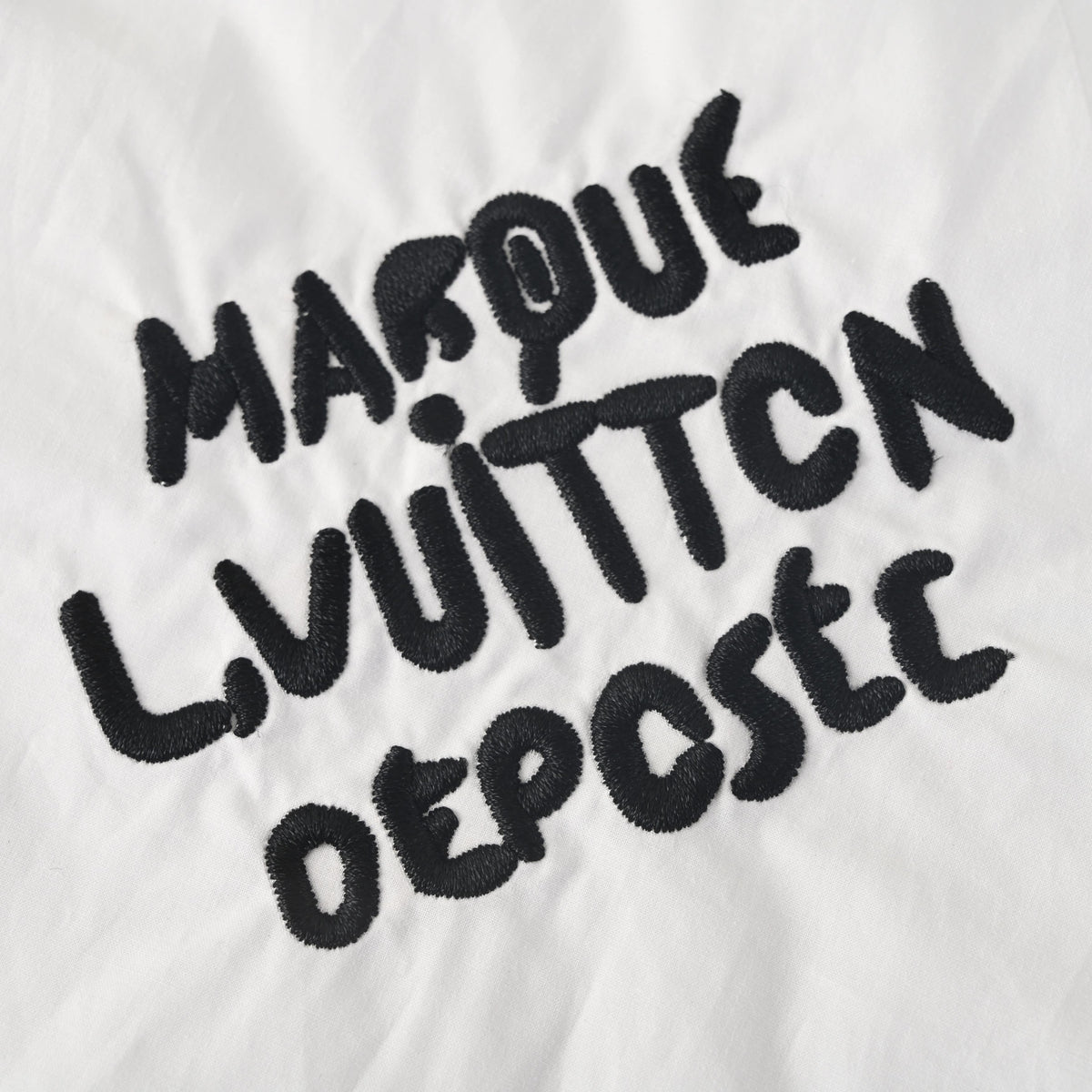 Louis Vuitton White Long-Sleeve Button-Up Shirt with Black Letter Embroidery, Drop-Shoulder Silhouette, Shell Buttons and Curved High-Low Hem